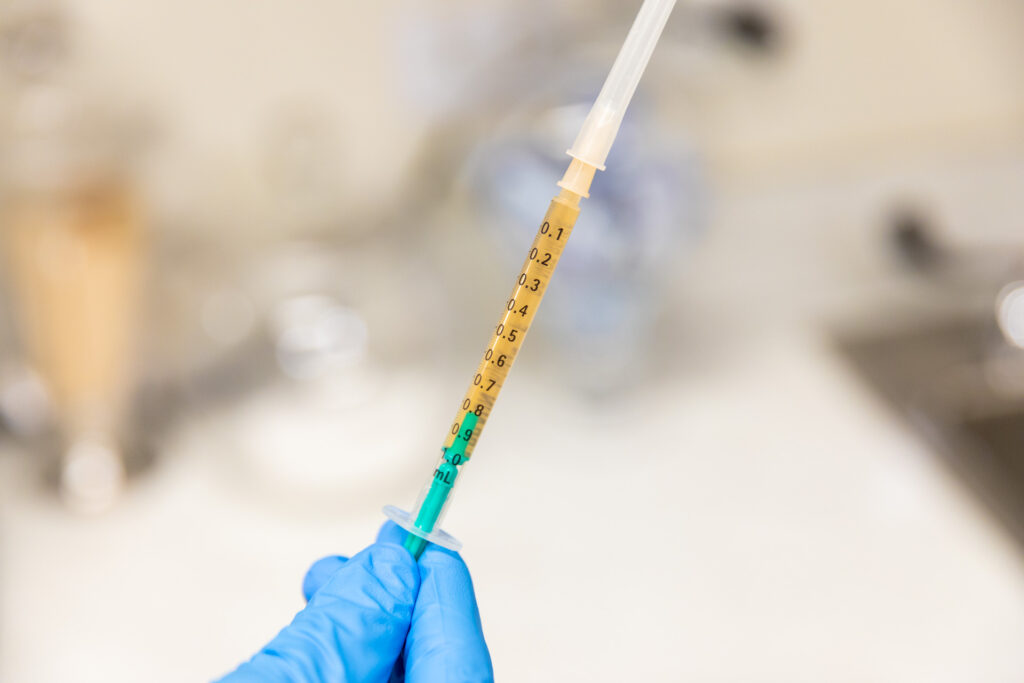 Syringe filled with platelet-rich plasma for hair restoration at Catara Med Spa in Algonquin, IL. Prepared for PRP scalp injection procedure.