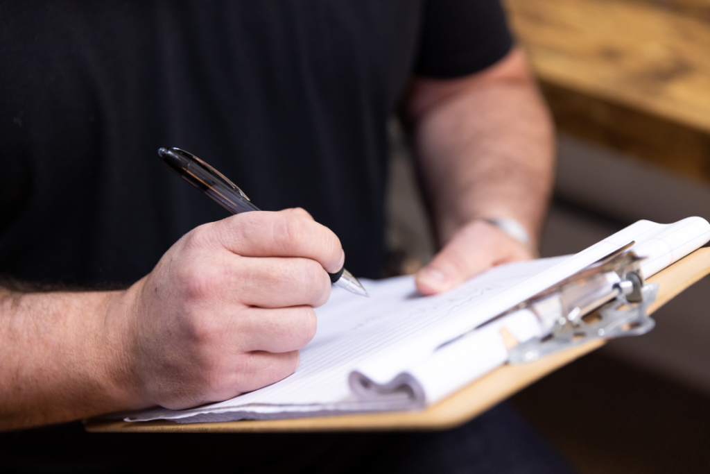 Client filling out intake form at Catara Med Spa in Algonquin, IL. Consultation and personalized treatment planning on clipboard.