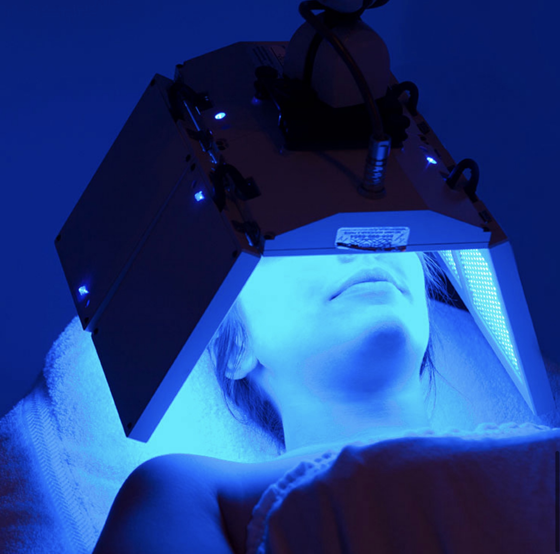 Client receiving blue light therapy at Catara Med Spa in Algonquin, IL using a professional LED light device.