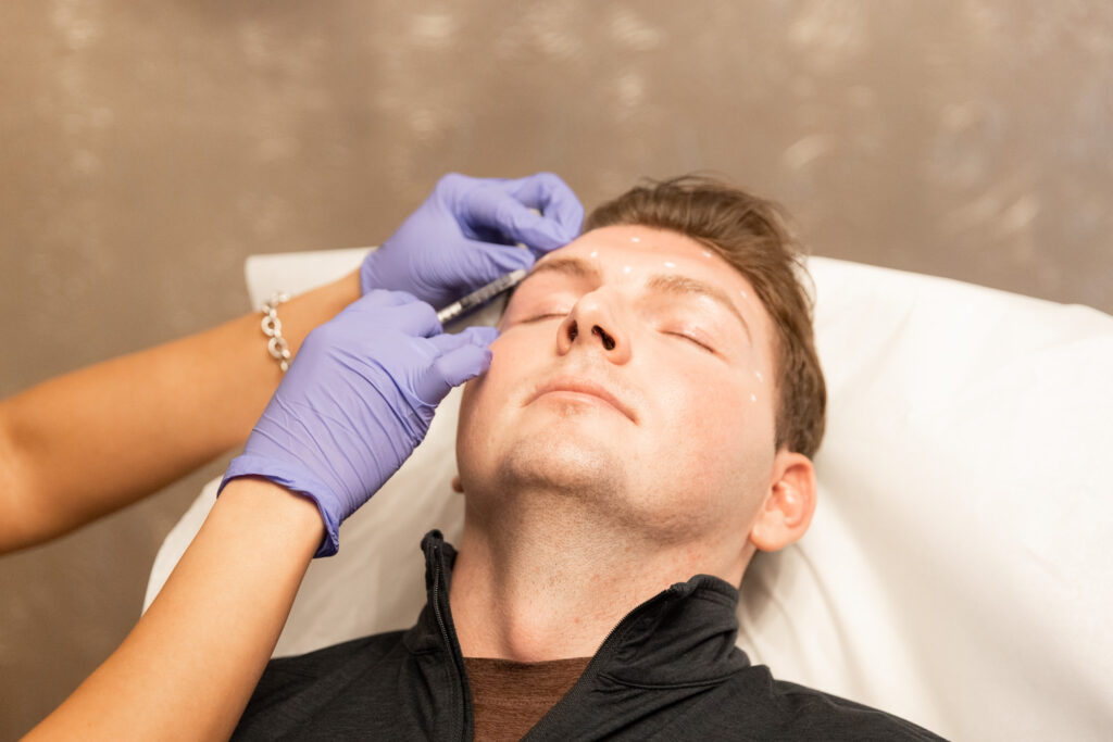 Male client receiving Botox injection for forehead wrinkles at Catara Med Spa in Algonquin, IL — professional Botox near me.