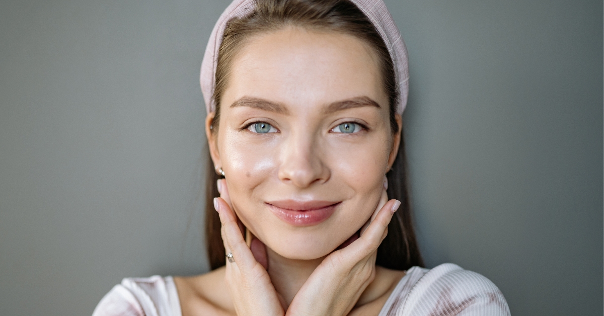 Woman with glowing, clear skin after a basic facial at Catara Med Spa, promoting hydration and radiance