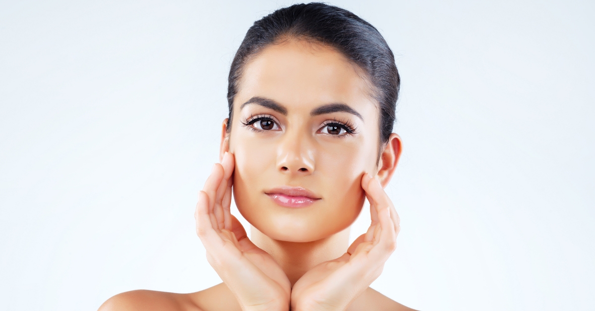 A woman with smooth, glowing skin after dermaplaning—learn how often you should dermaplane for best results at Catara Med Spa.